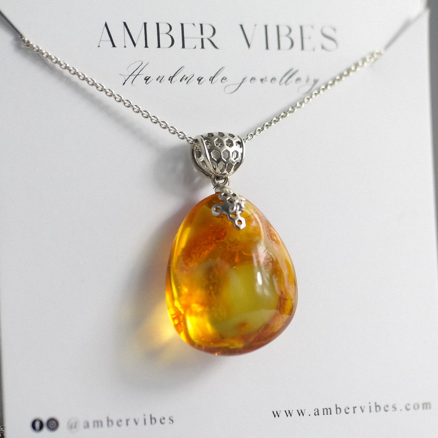 Silver pendant with natural Baltic amber piece