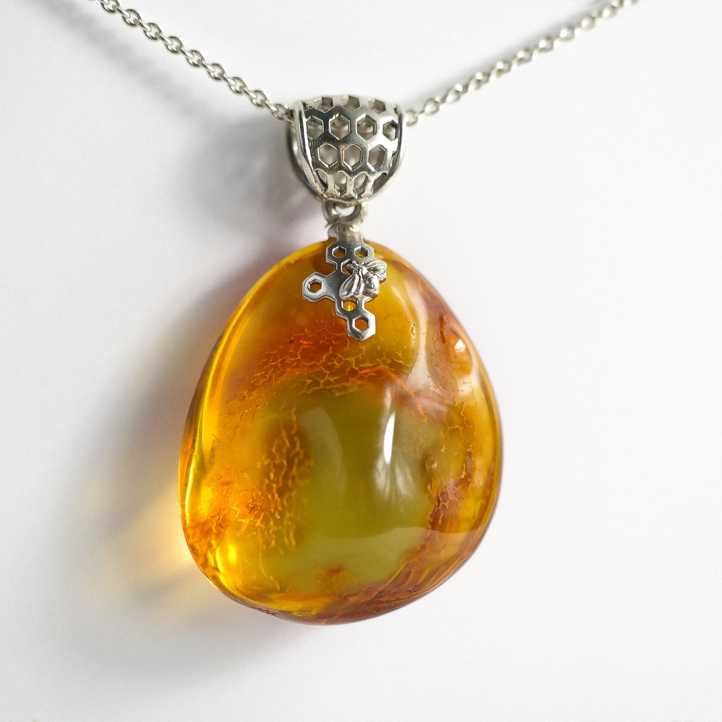 Silver pendant with natural Baltic amber piece