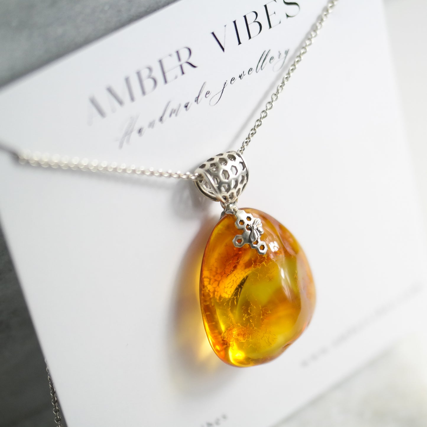 Silver pendant with natural Baltic amber piece