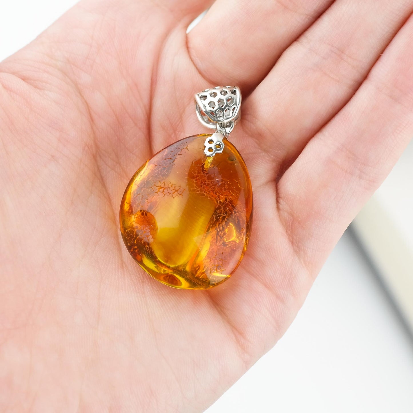 Silver pendant with natural Baltic amber piece