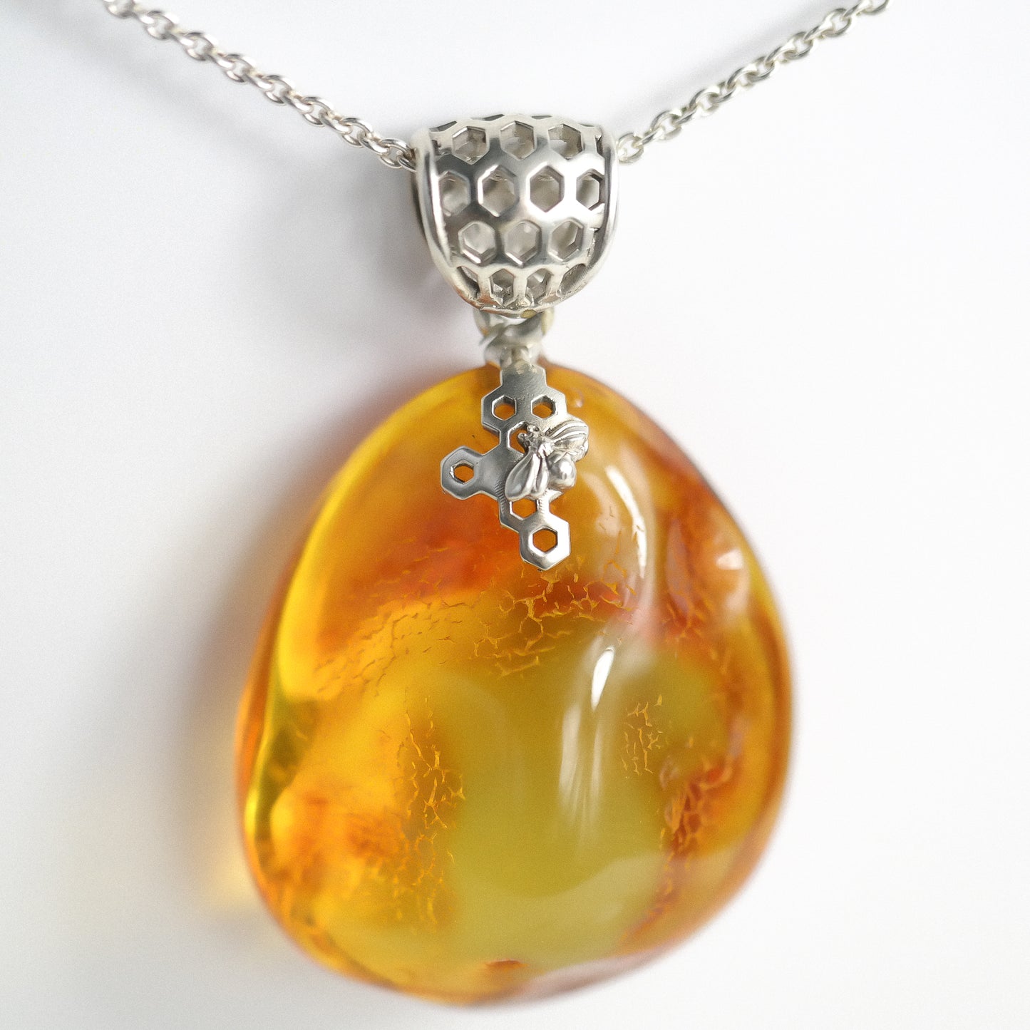 Silver pendant with natural Baltic amber piece