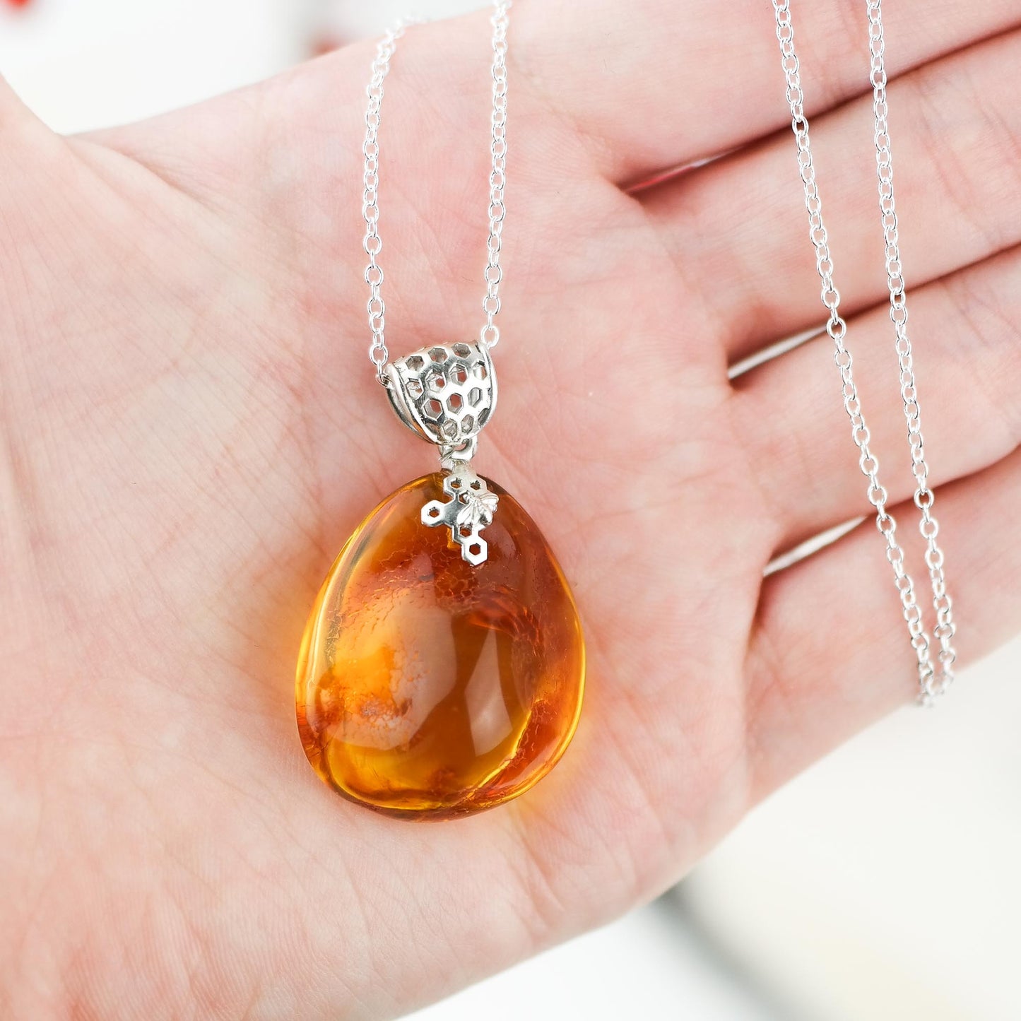Silver pendant with natural Baltic amber piece