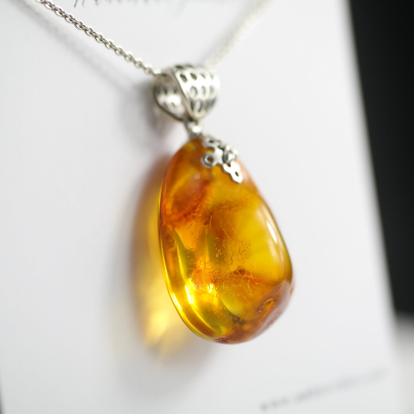 Silver pendant with natural Baltic amber piece