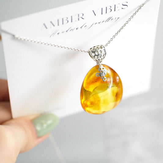 Silver pendant with natural Baltic amber piece