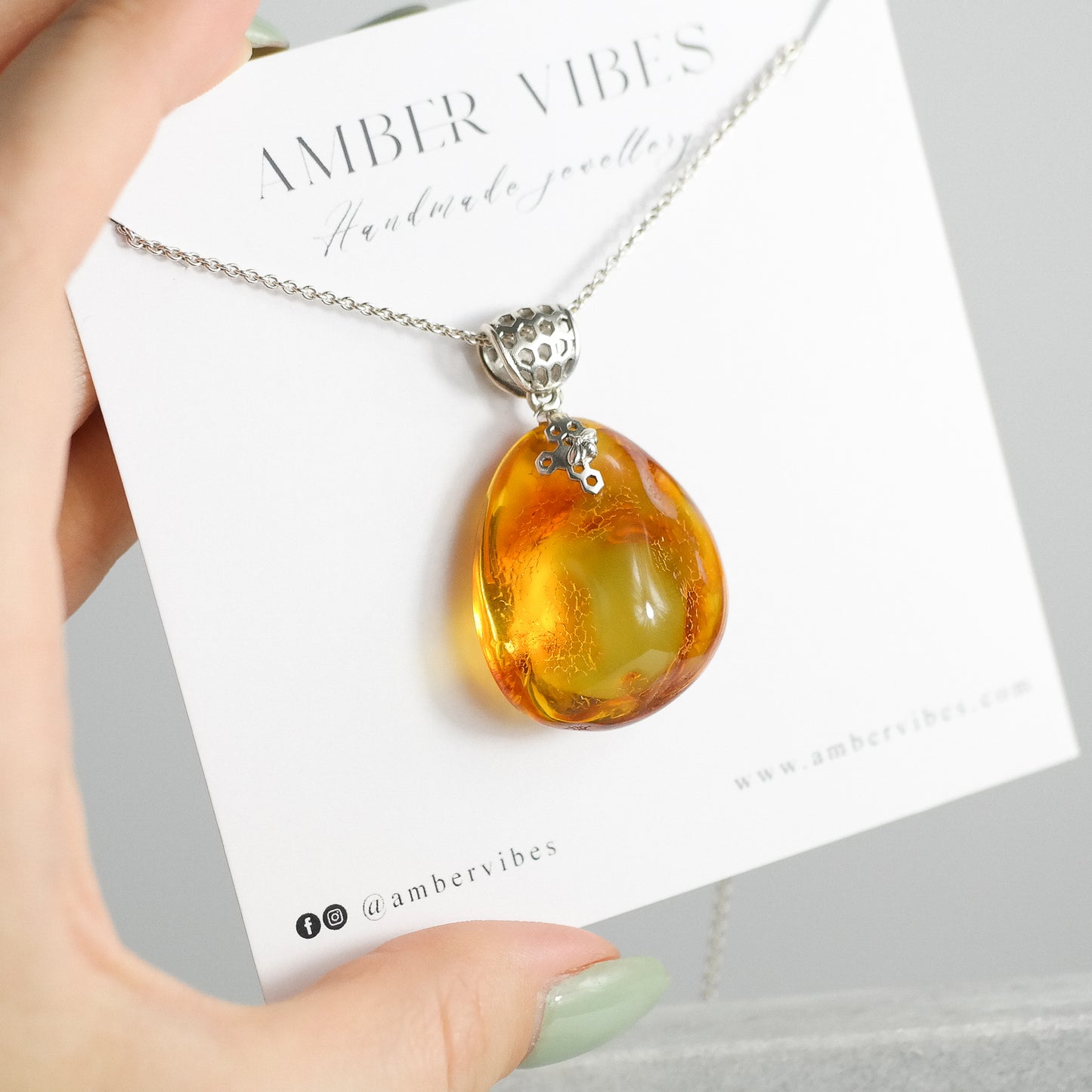Silver pendant with natural Baltic amber piece