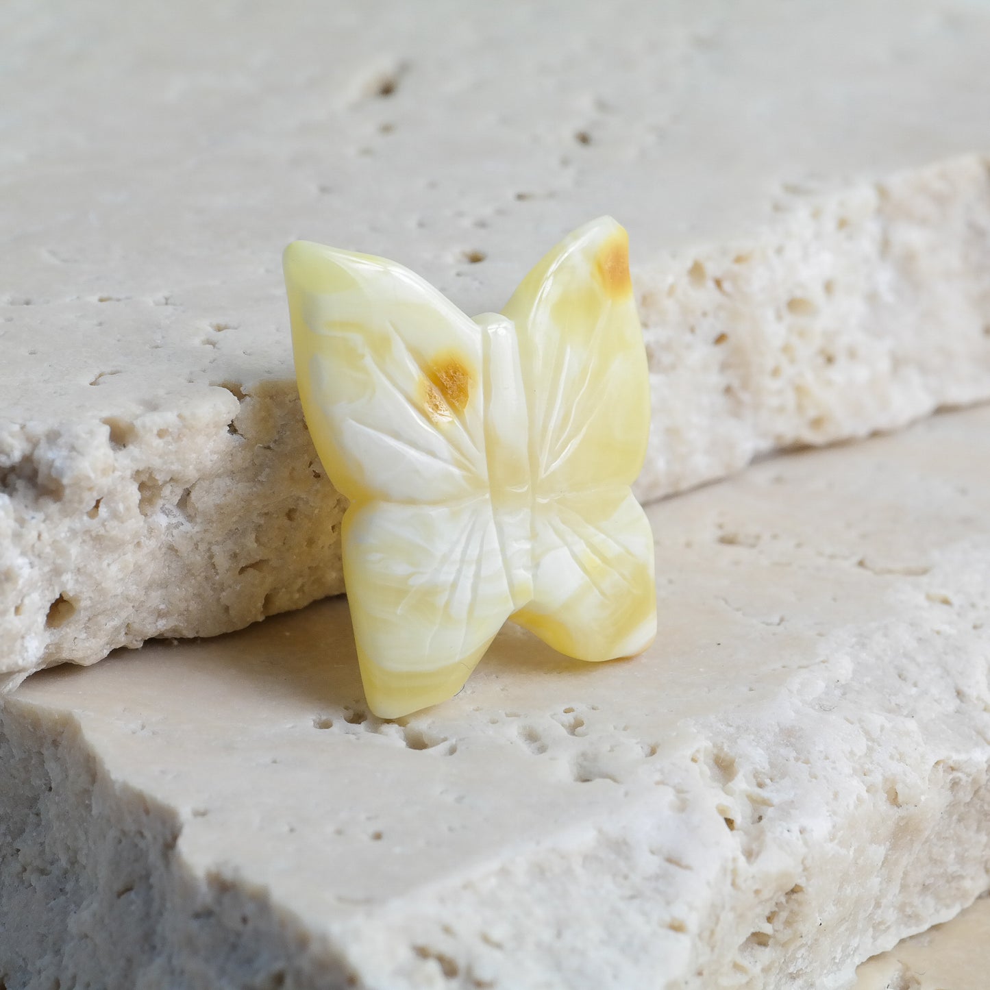 Hand carved white amber butterfly figurines
