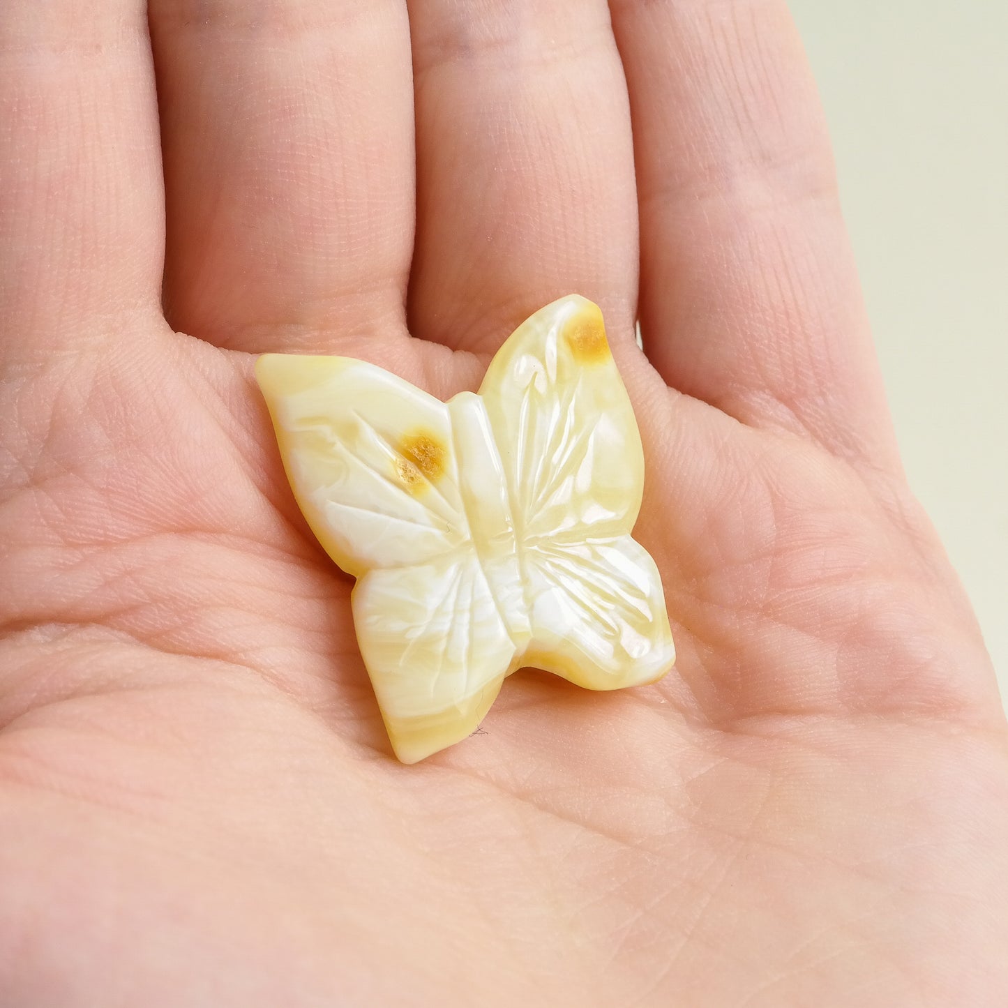Hand carved white amber butterfly figurines