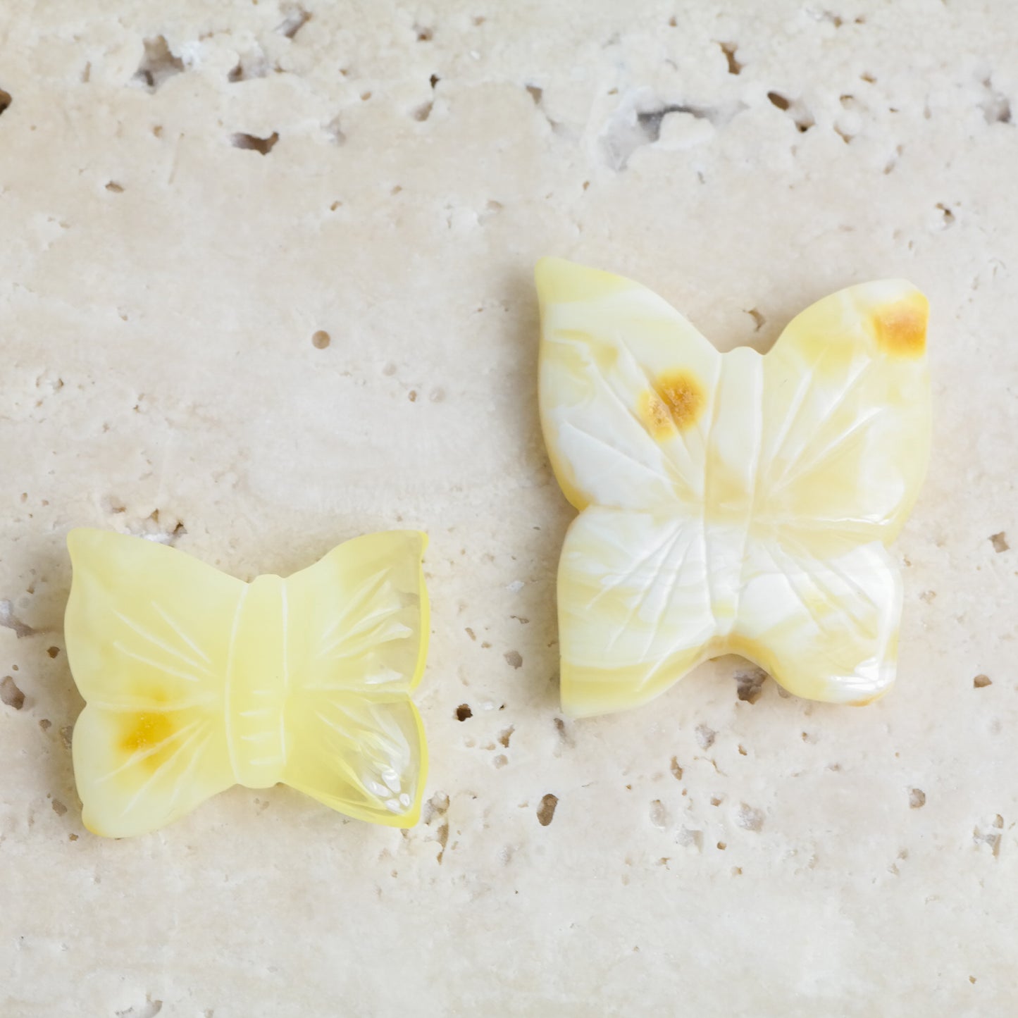 Hand carved white amber butterfly figurines