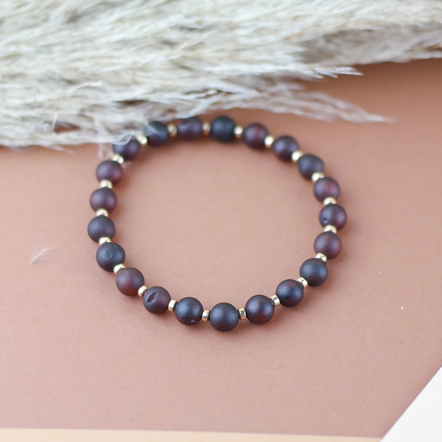Handmade amber bracelet with gold colour hematite details