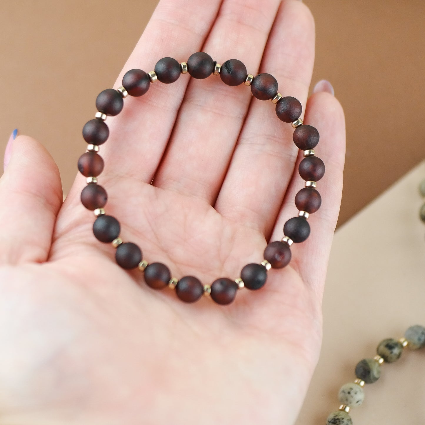 Handmade amber bracelet with gold colour hematite details