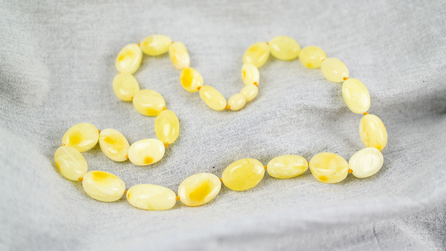 Amber necklace from milky yellow, bean shaped amber beads