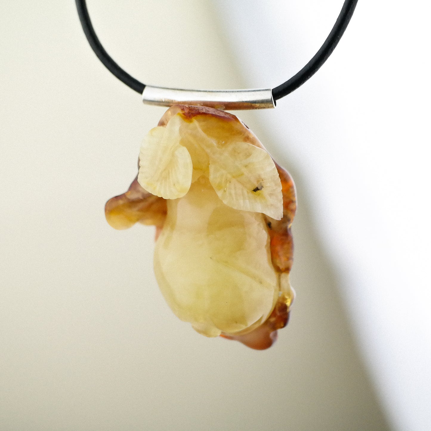 Hand carved amber flower pendant