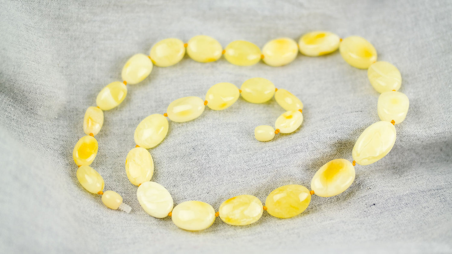 Amber necklace from milky yellow, bean shaped amber beads