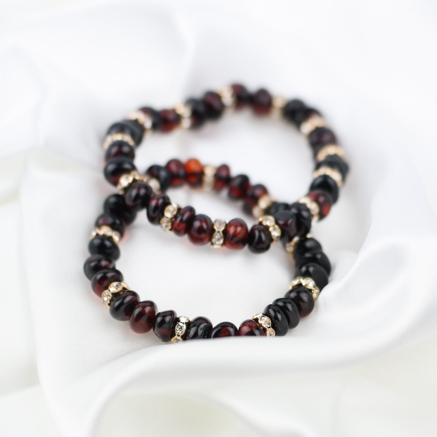 Cherry amber bracelets with gold colour spacers