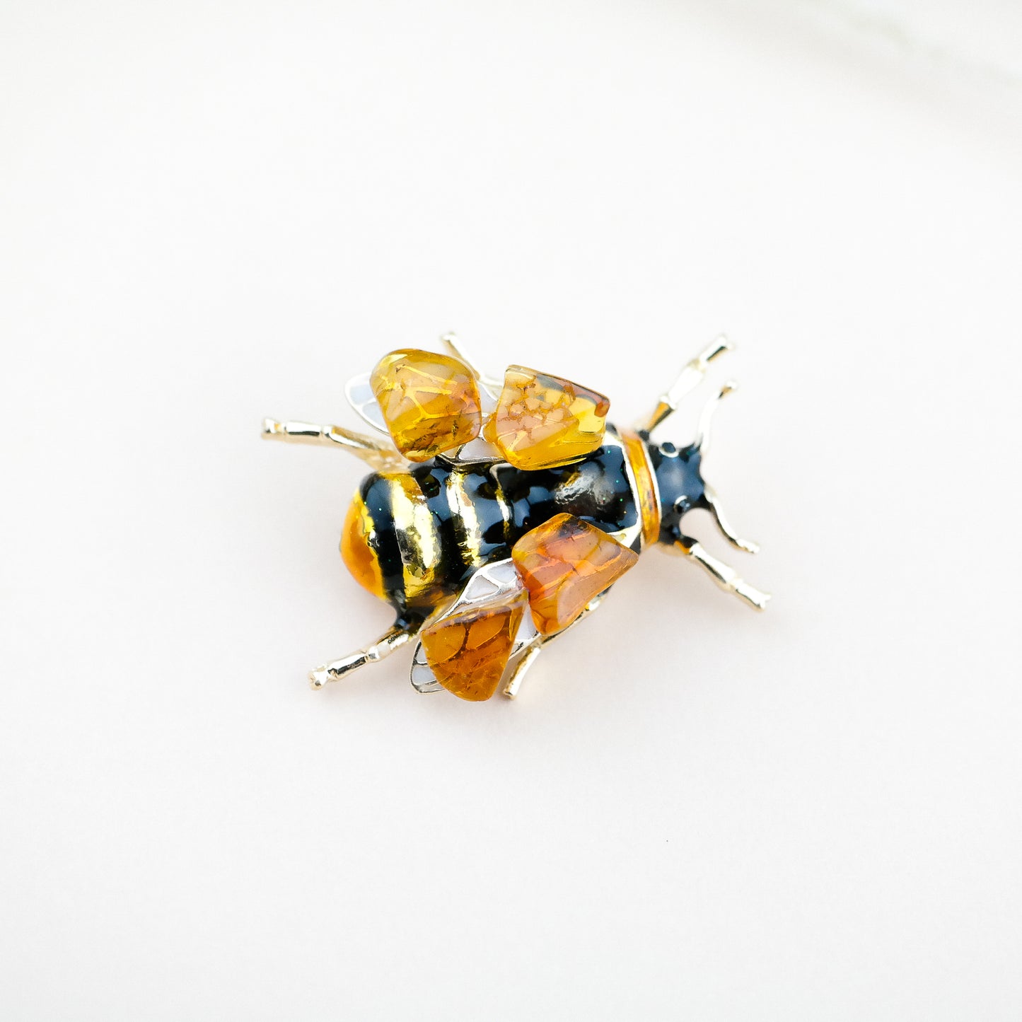 Bee brooches with natural amber