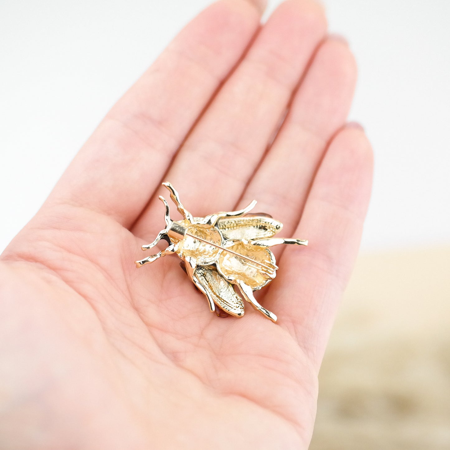 Bee brooches with natural amber