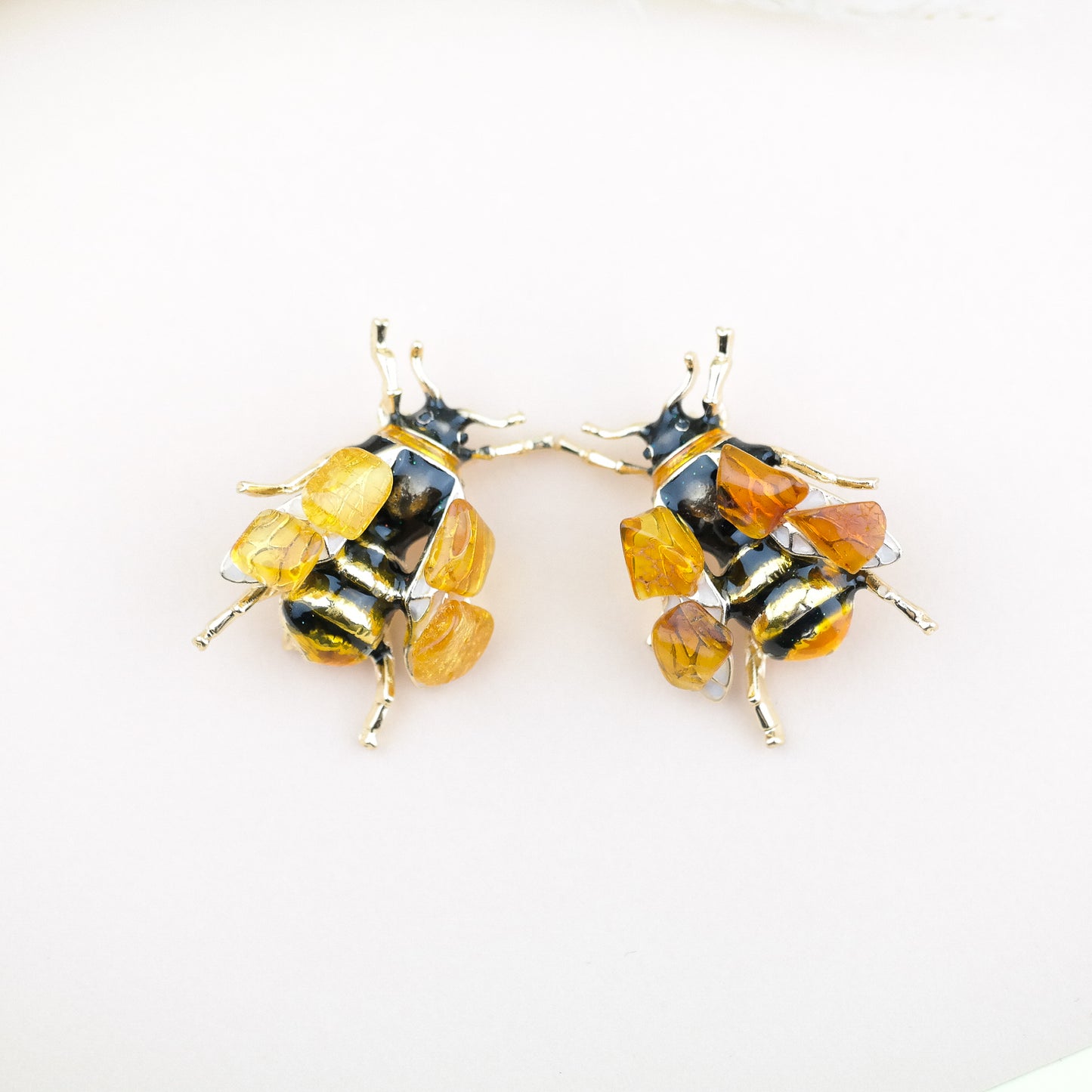 Bee brooches with natural amber