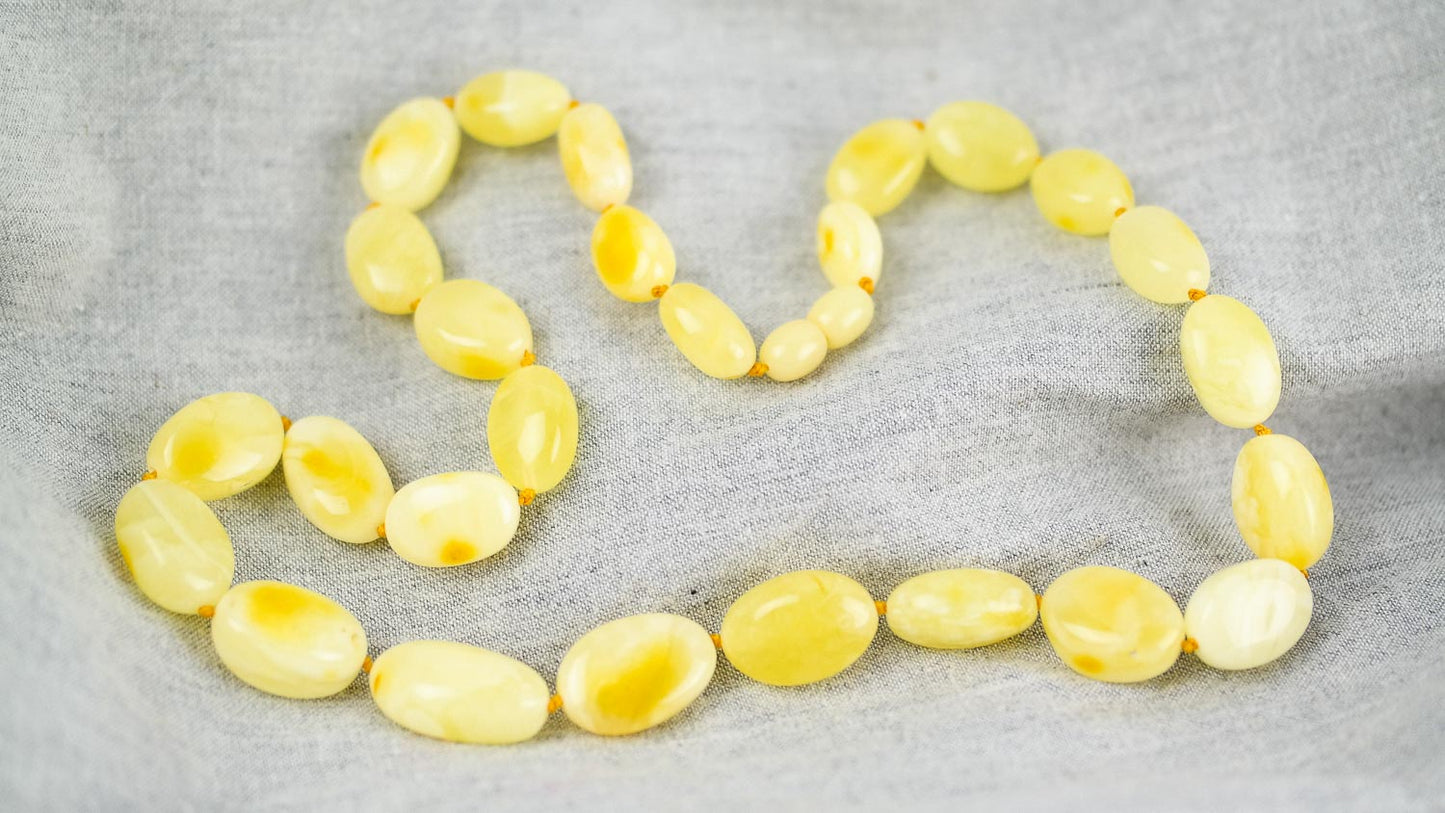 Amber necklace from milky yellow, bean shaped amber beads