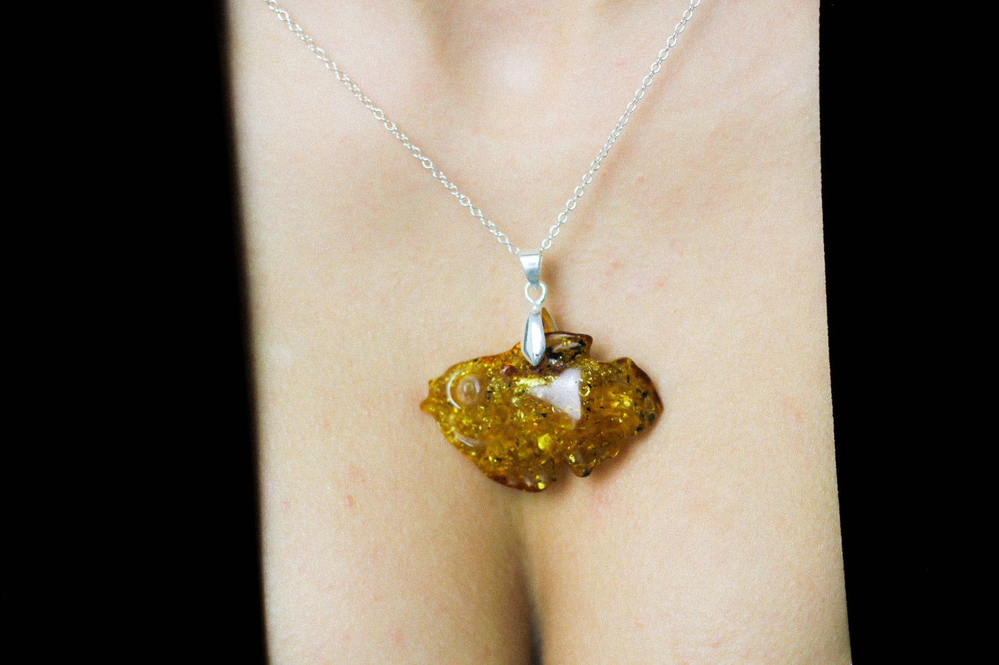 Amber pendant hand carved into a fish
