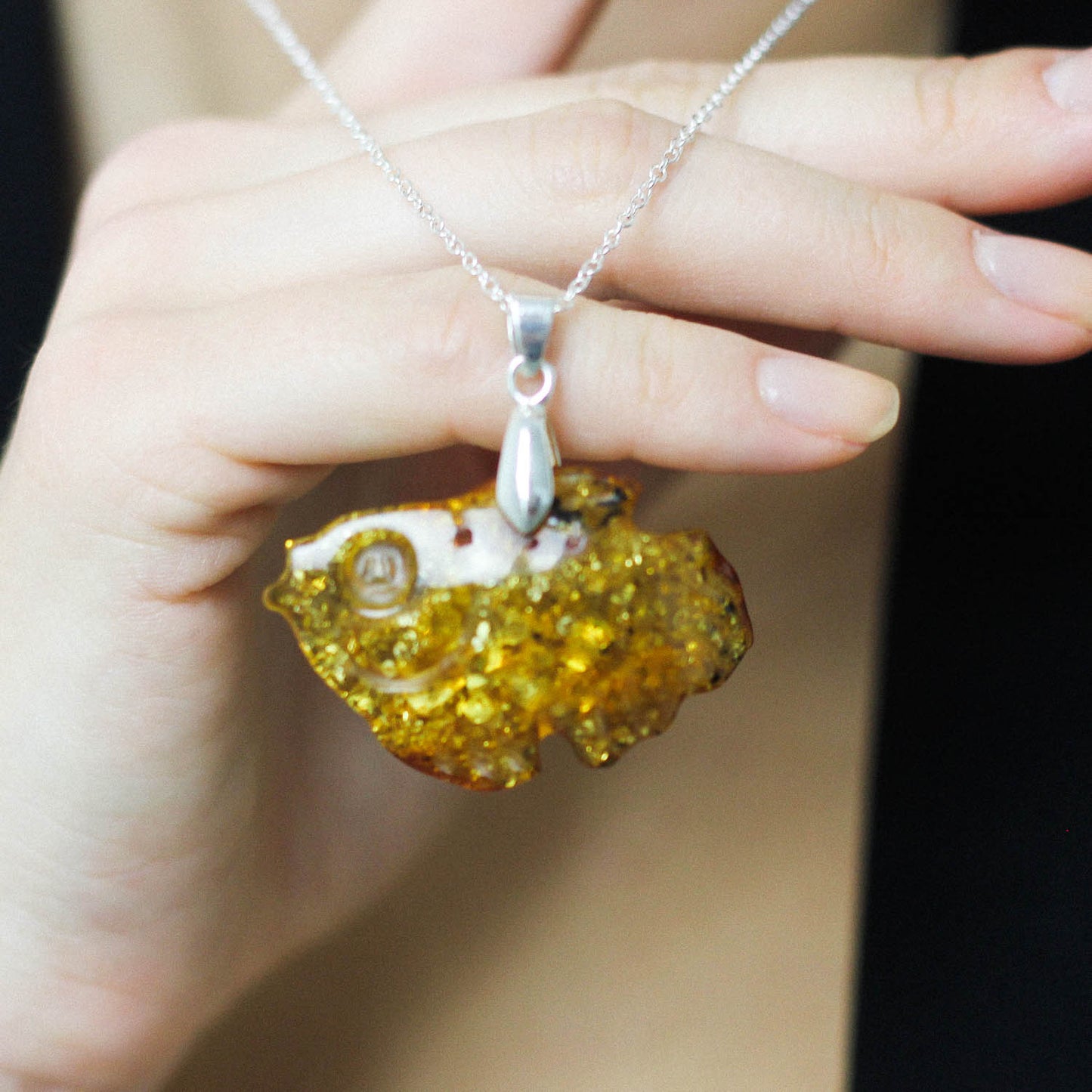 Amber pendant hand carved into a fish
