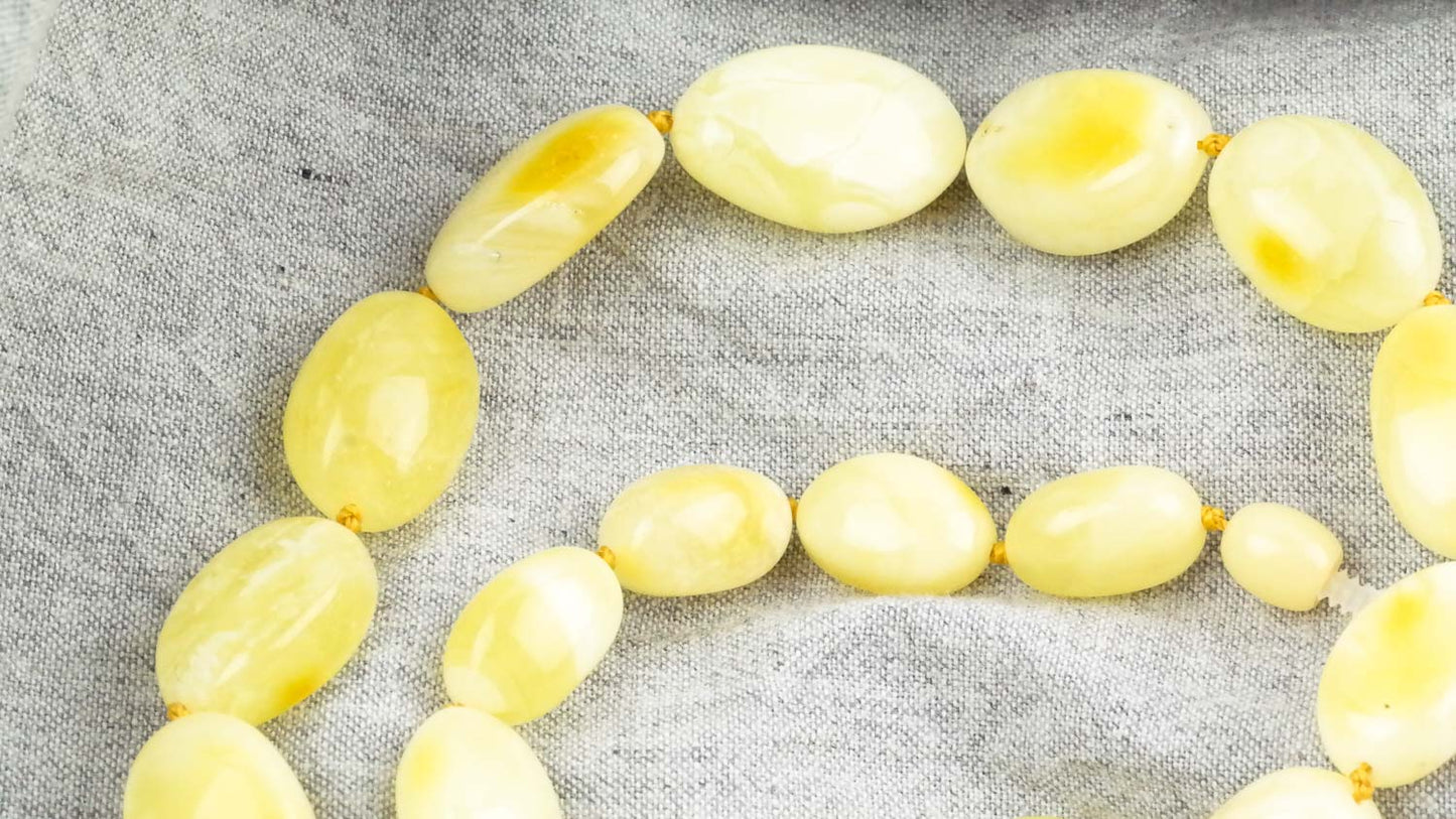 Amber necklace from milky yellow, bean shaped amber beads