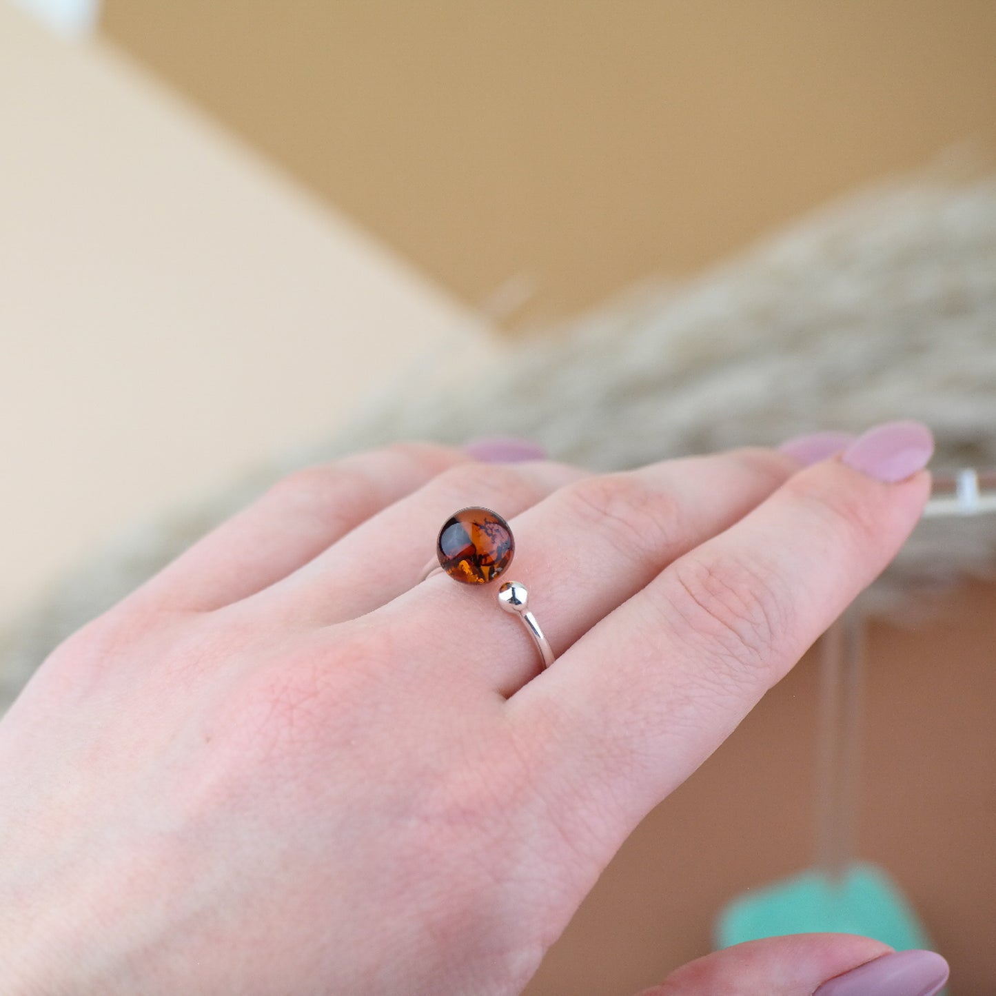 Silver ring with natural amber bead