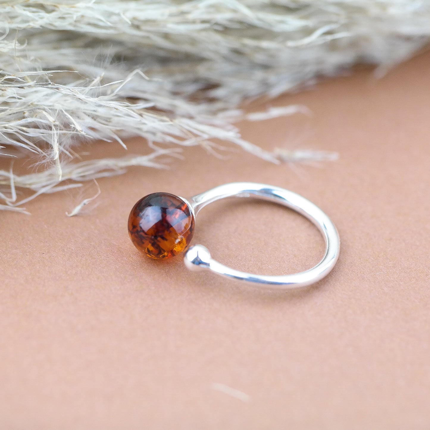 Silver ring with natural amber bead