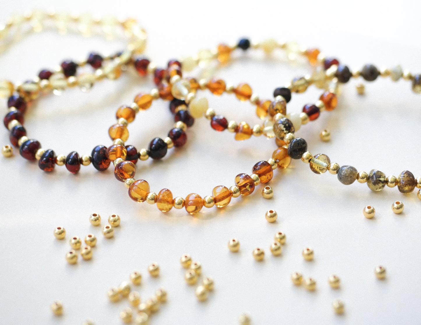 Chic amber bracelets with gold colour spacers