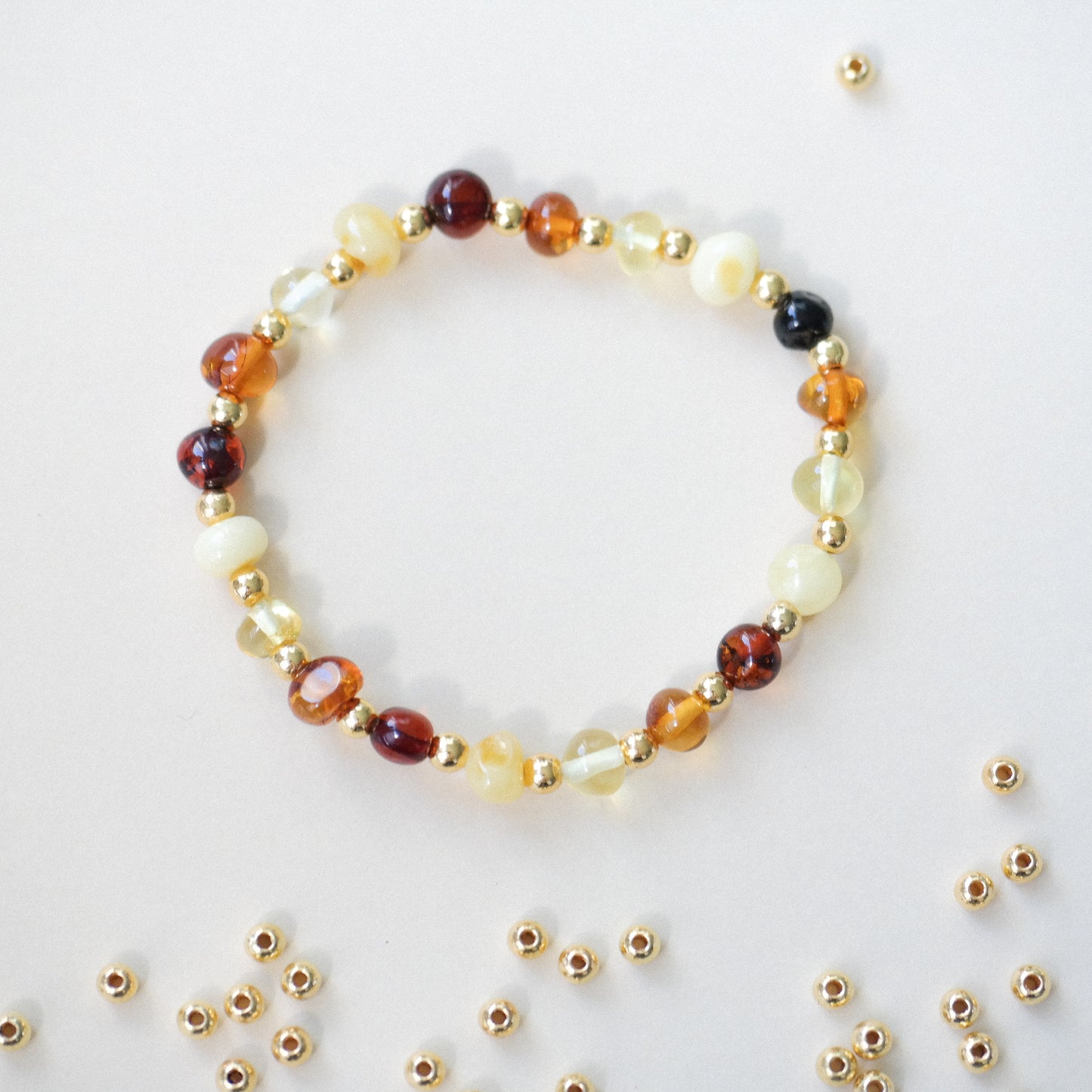 Chic amber bracelets with gold colour spacers