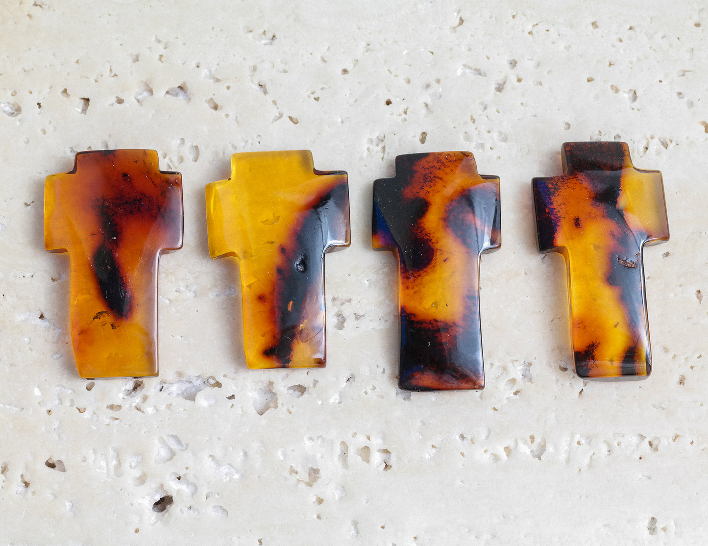 Hand carved crosses from natural Baltic amber