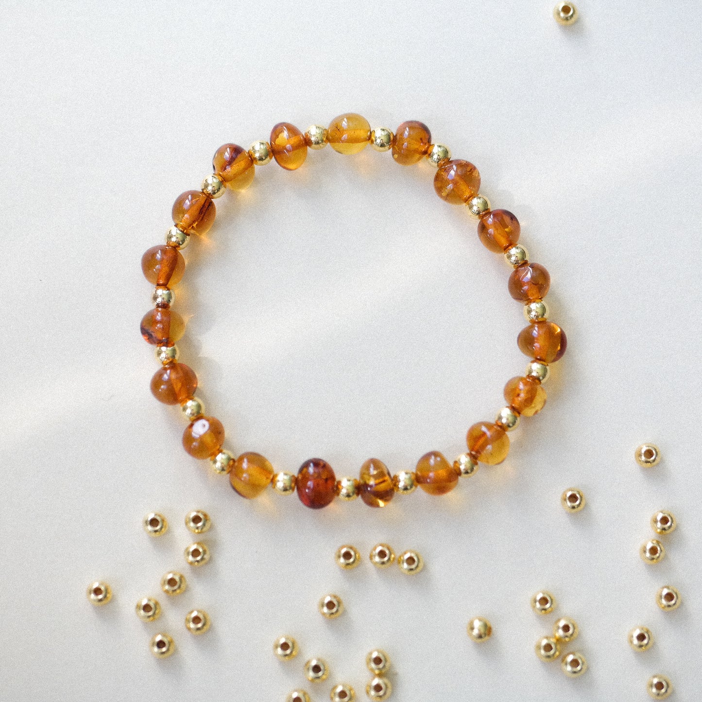 Chic amber bracelets with gold colour spacers