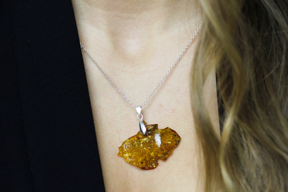 Amber pendant hand carved into a fish