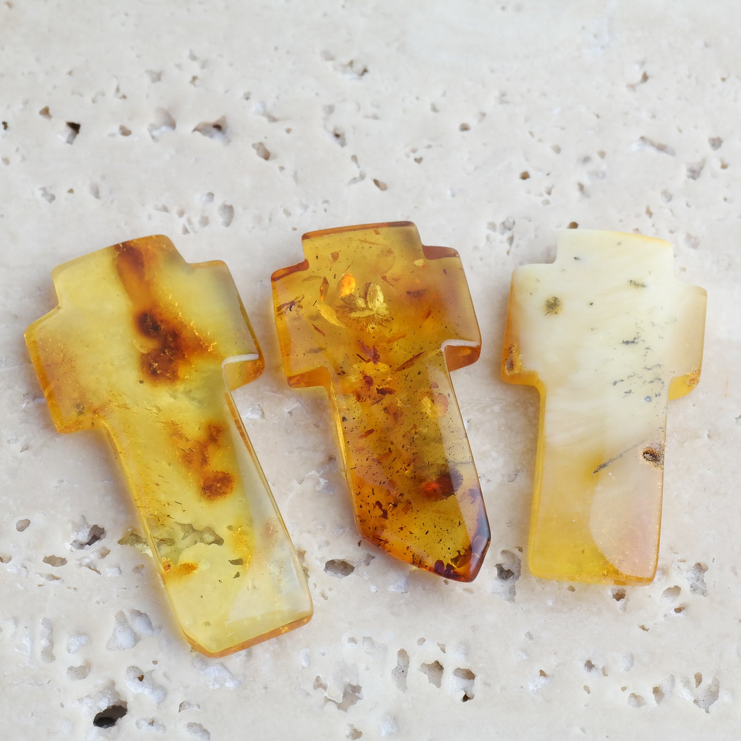 Beautiful hand carved crosses from natural Baltic amber