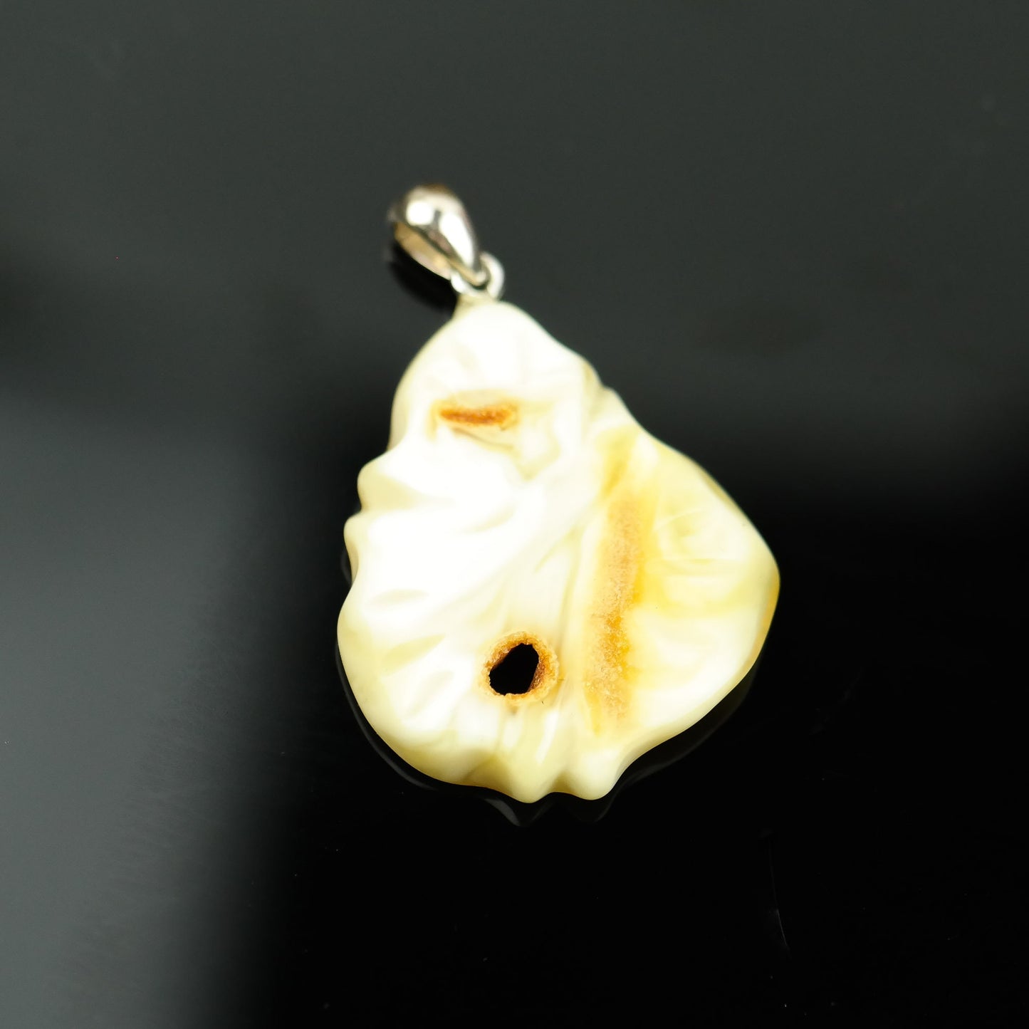 Hand carved amber pendant
