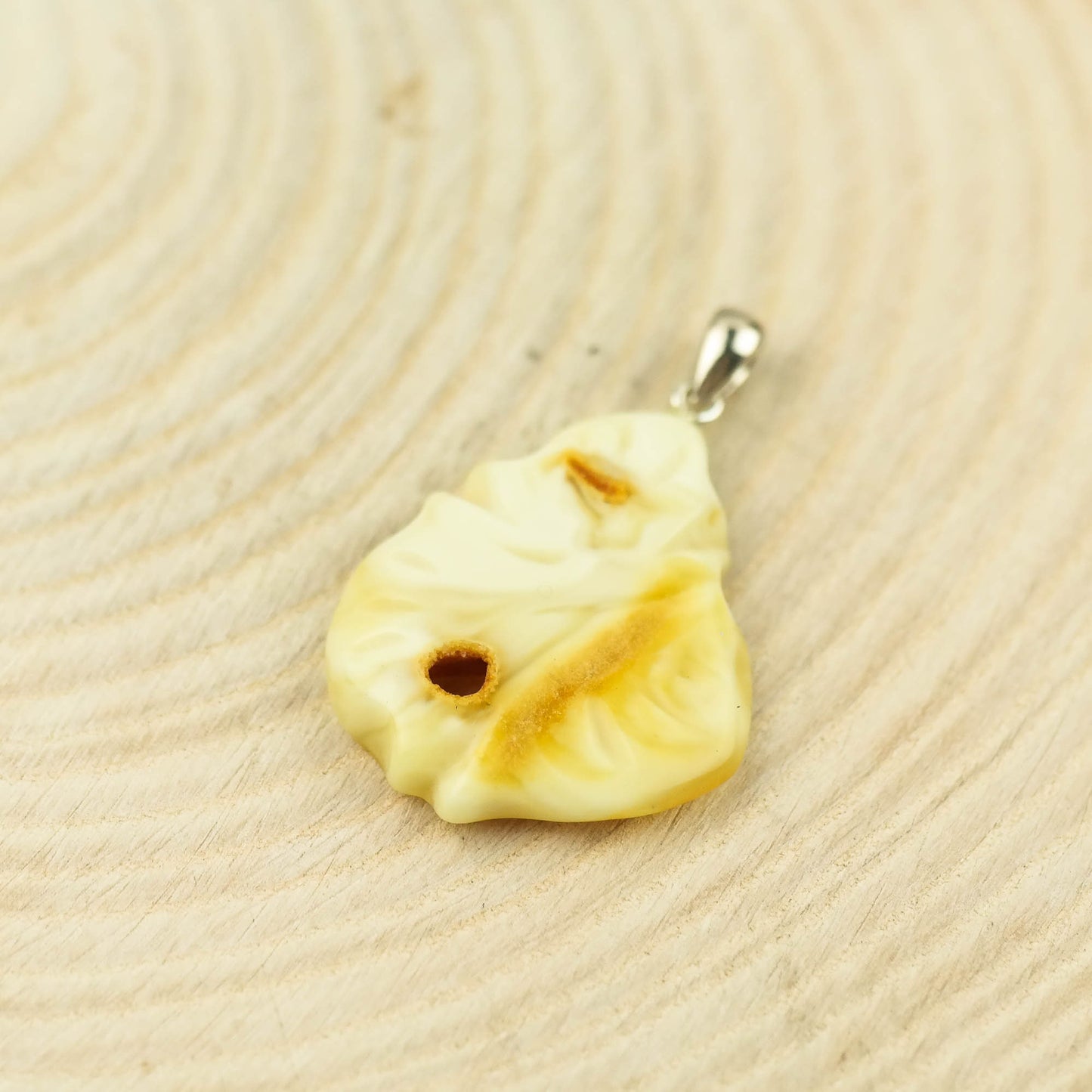 Hand carved amber pendant