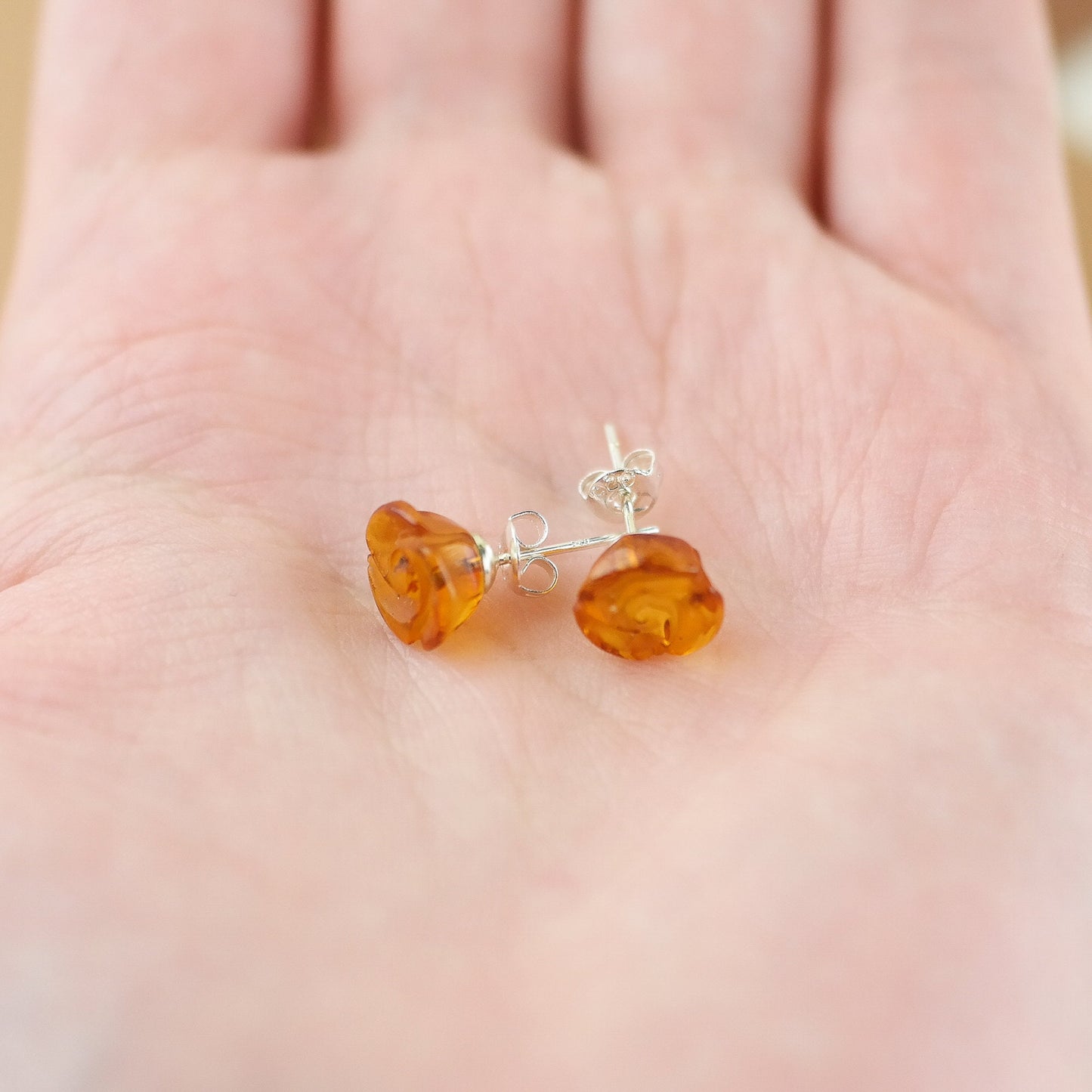Stud silver earrings with hand carved roses