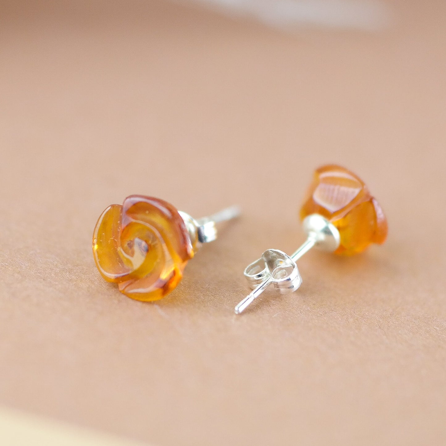 Stud silver earrings with hand carved roses