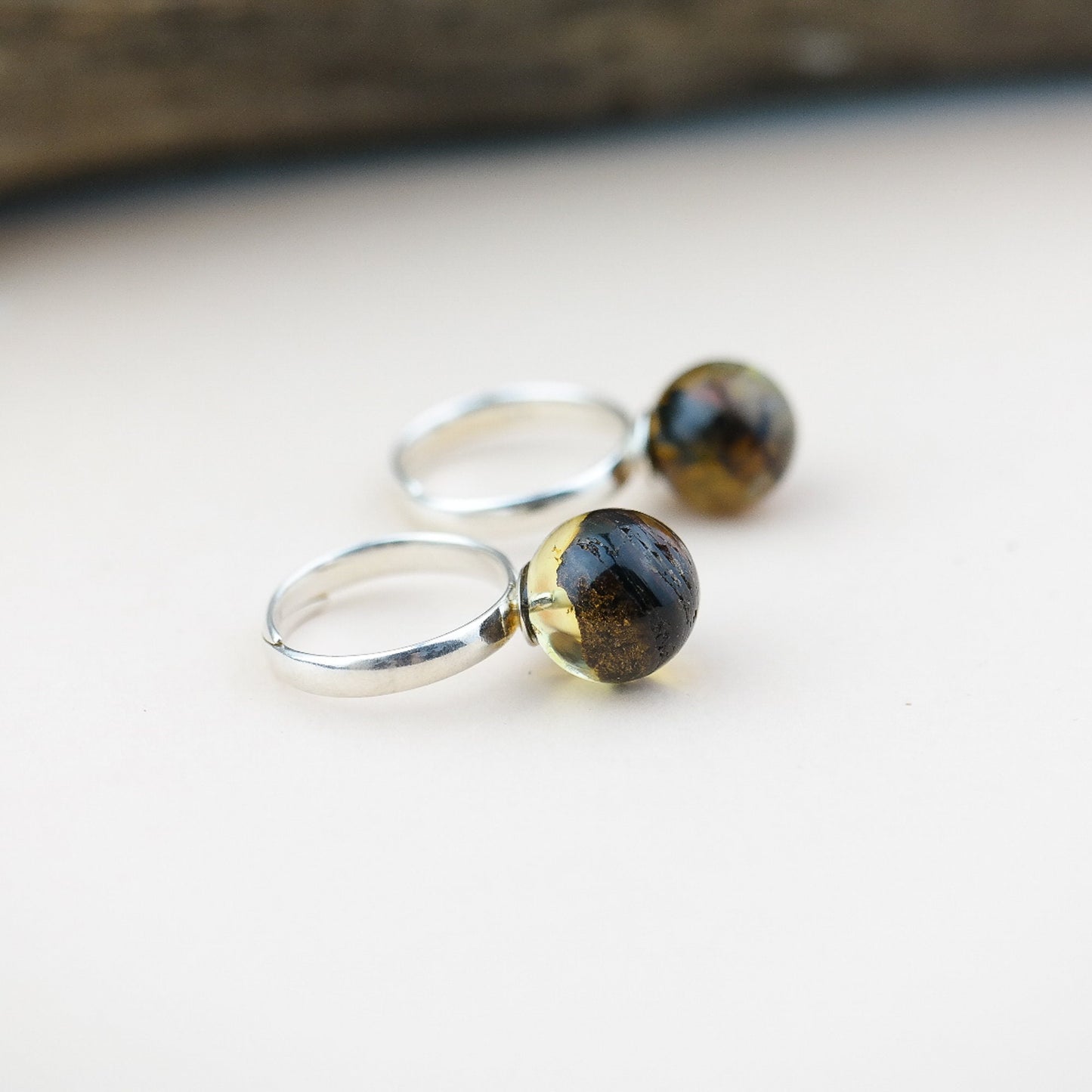 Adjustable silver ring with natural amber bead