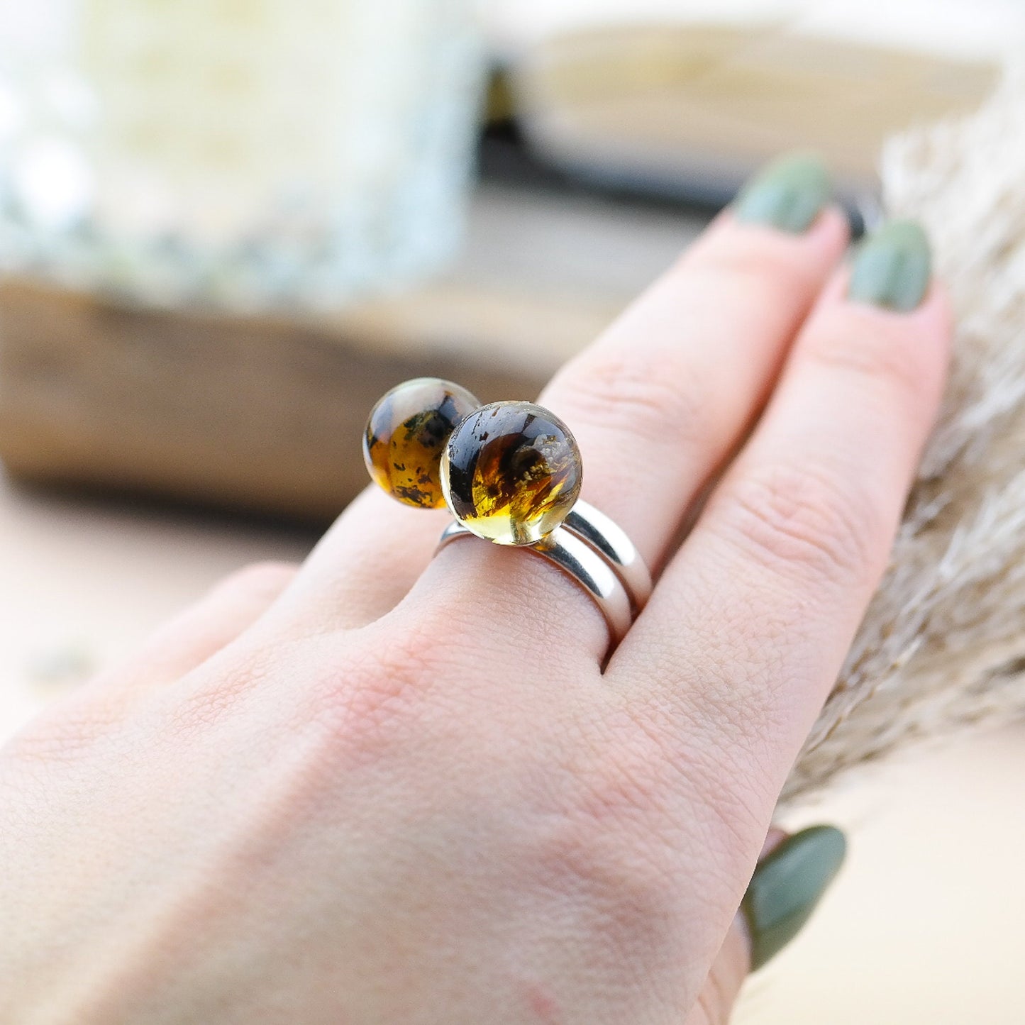 Adjustable silver ring with natural amber bead
