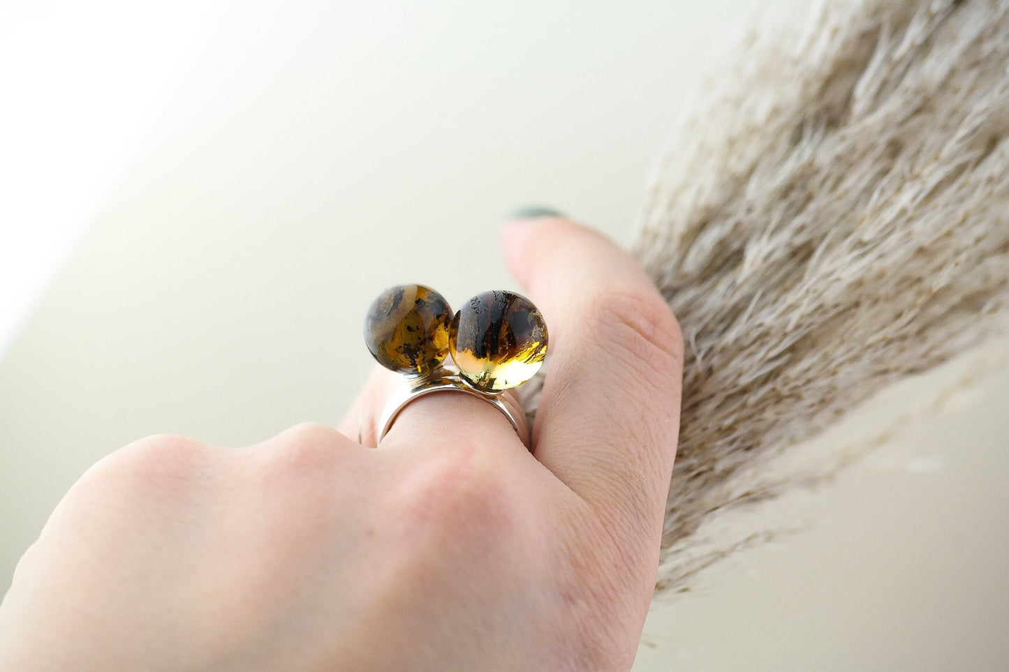Adjustable silver ring with natural amber bead
