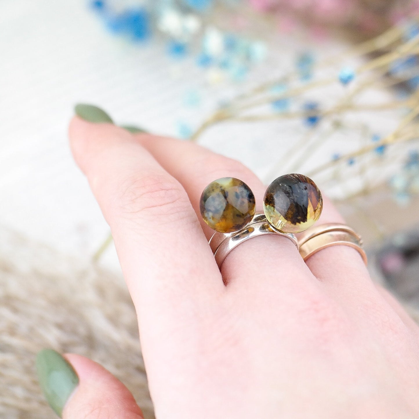 Adjustable silver ring with natural amber bead