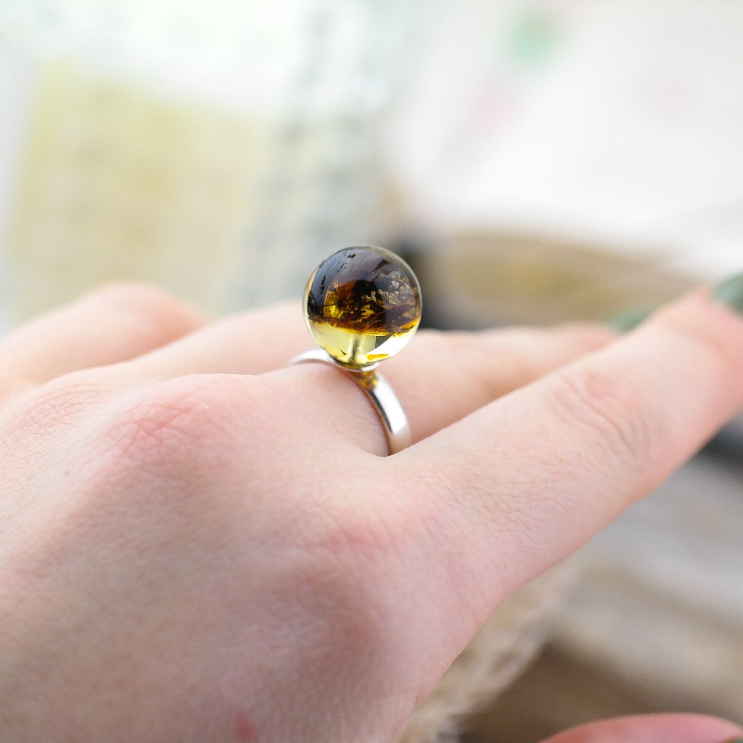 Adjustable silver ring with natural amber bead