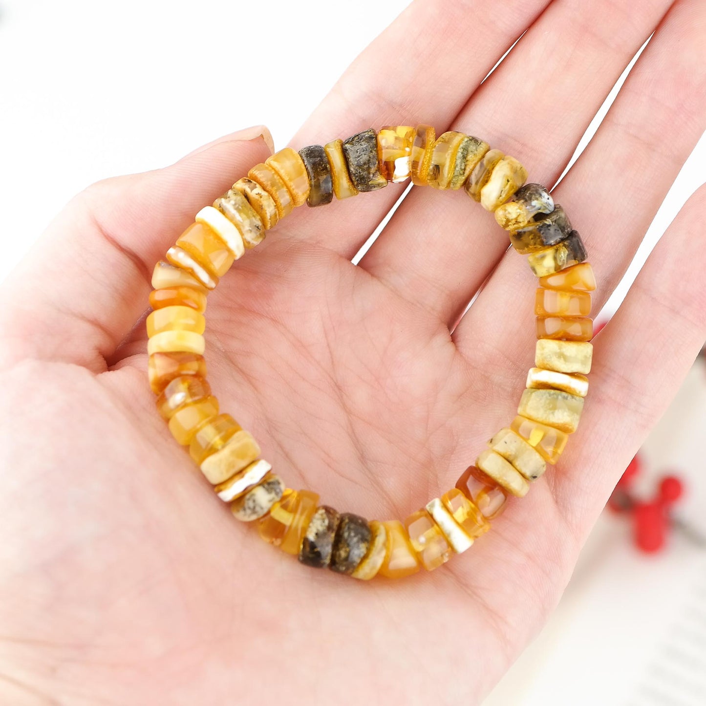 Colourful bracelet from tube shaped amber beads