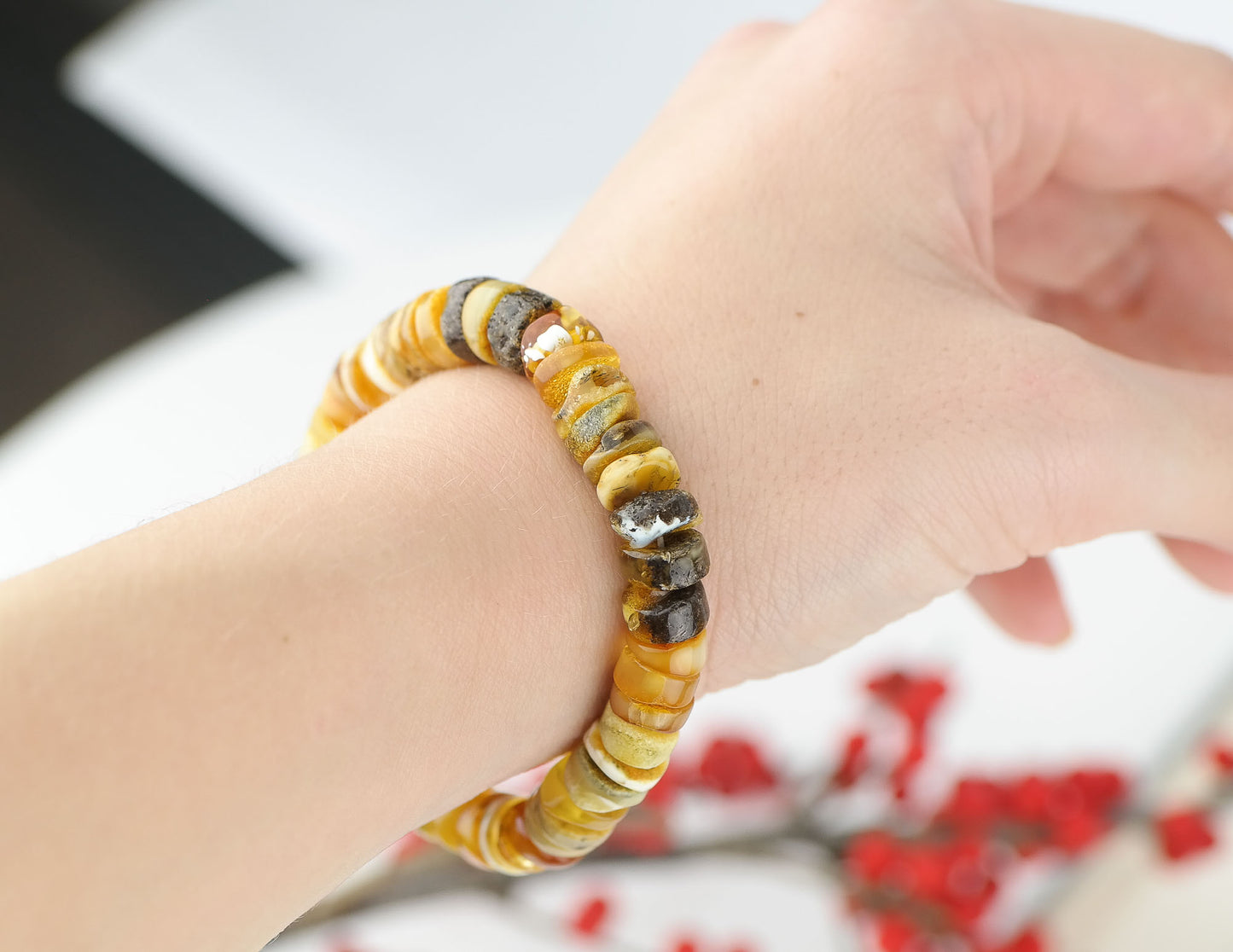 Colourful bracelet from tube shaped amber beads