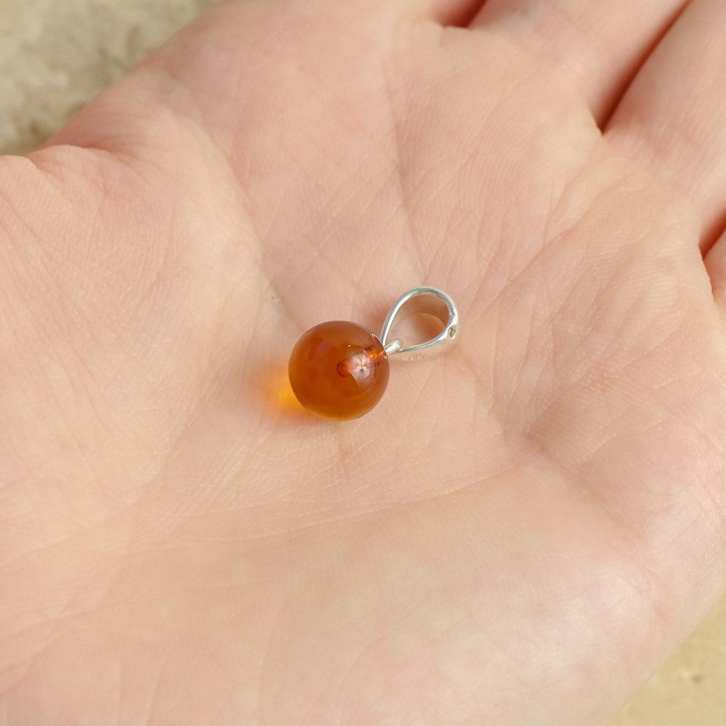 Chic and tiny natural Baltic amber ball pendant