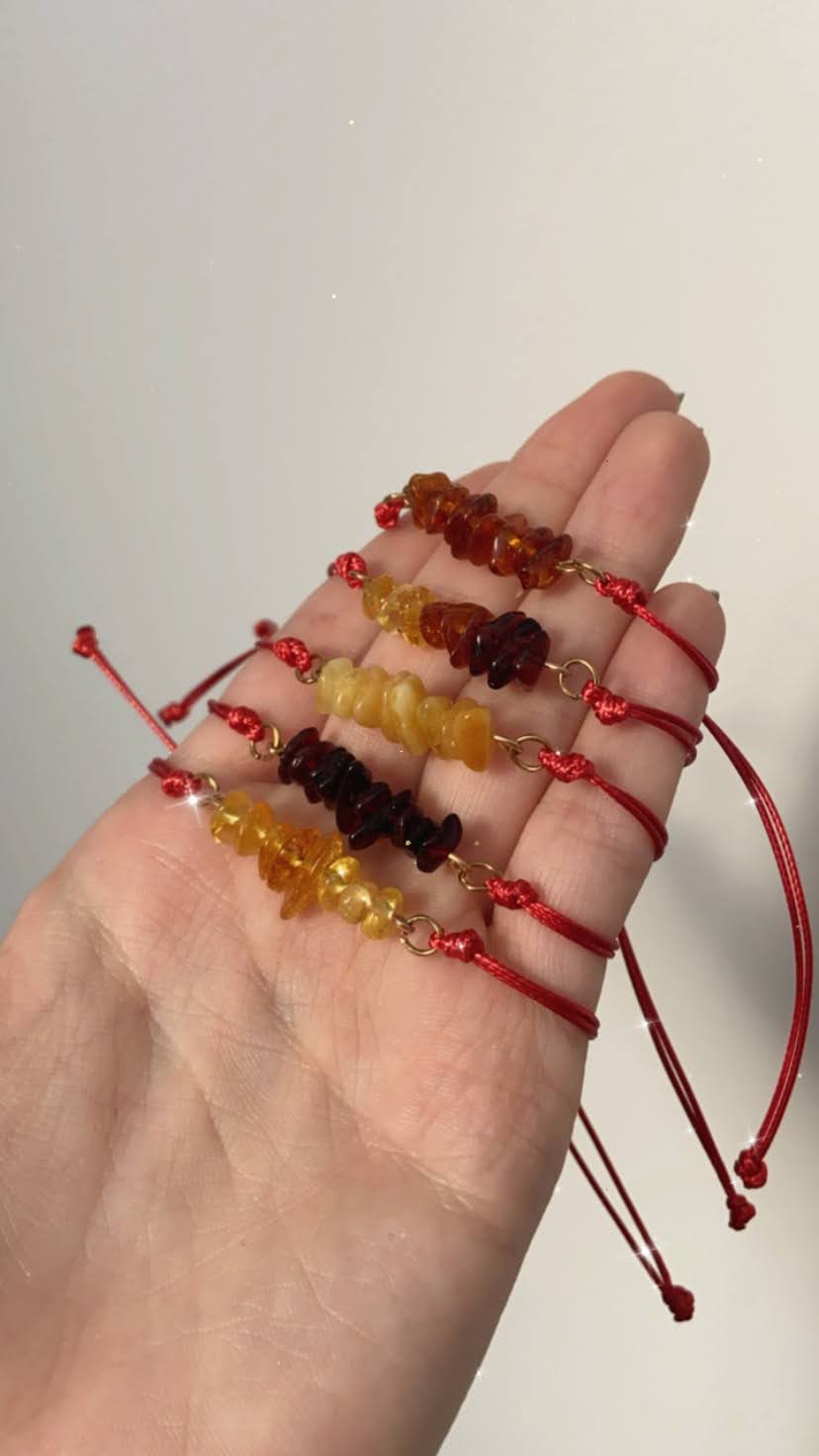 Red thread bracelet with natural Baltic amber