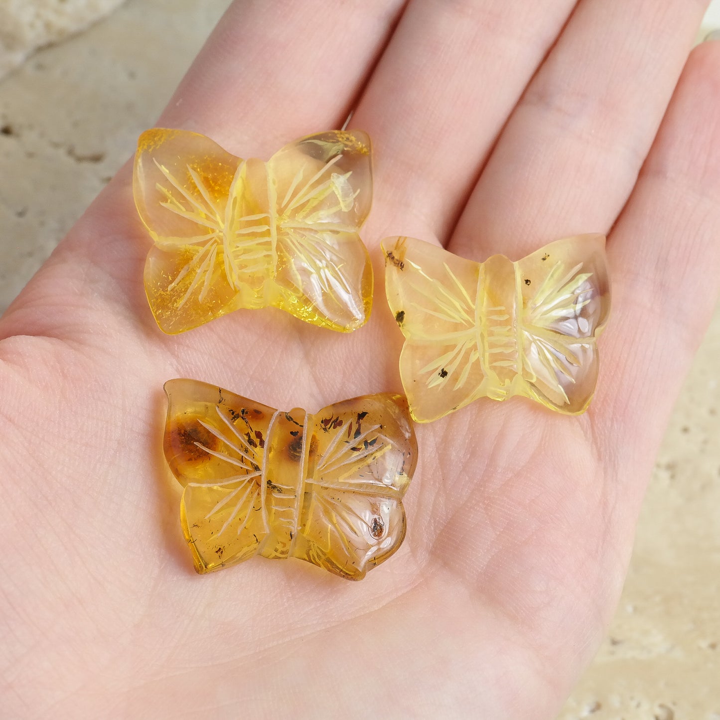 Hand carved butterfly figurines from natural Baltic amber