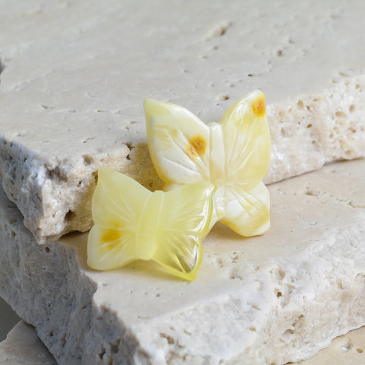 Hand carved white amber butterfly figurines