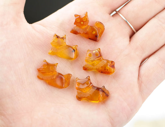 Hand carved kitten figurines from natural Baltic amber, perfect for jewelry making