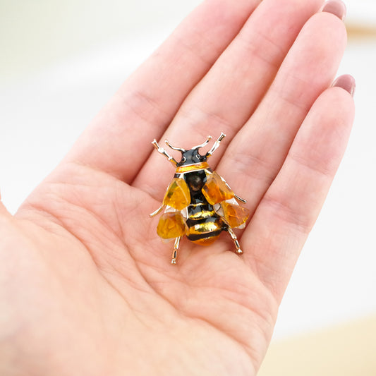 Bee brooches with natural amber